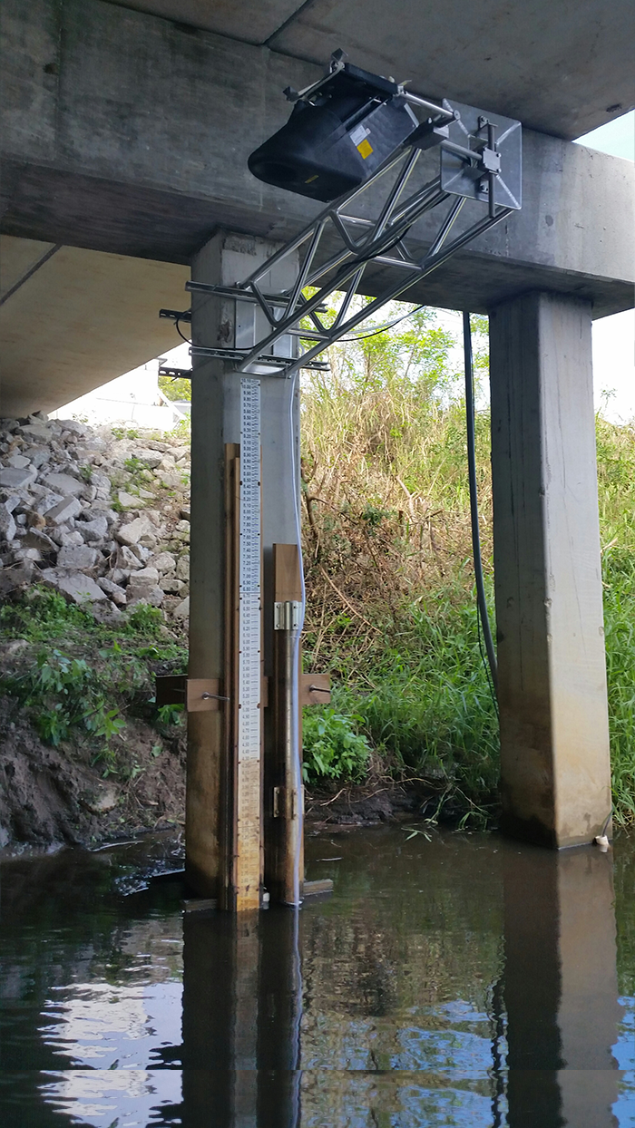 laser water flow sensor suspended from bridge